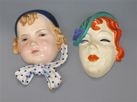 A Goldscheider face mask and another wall mask